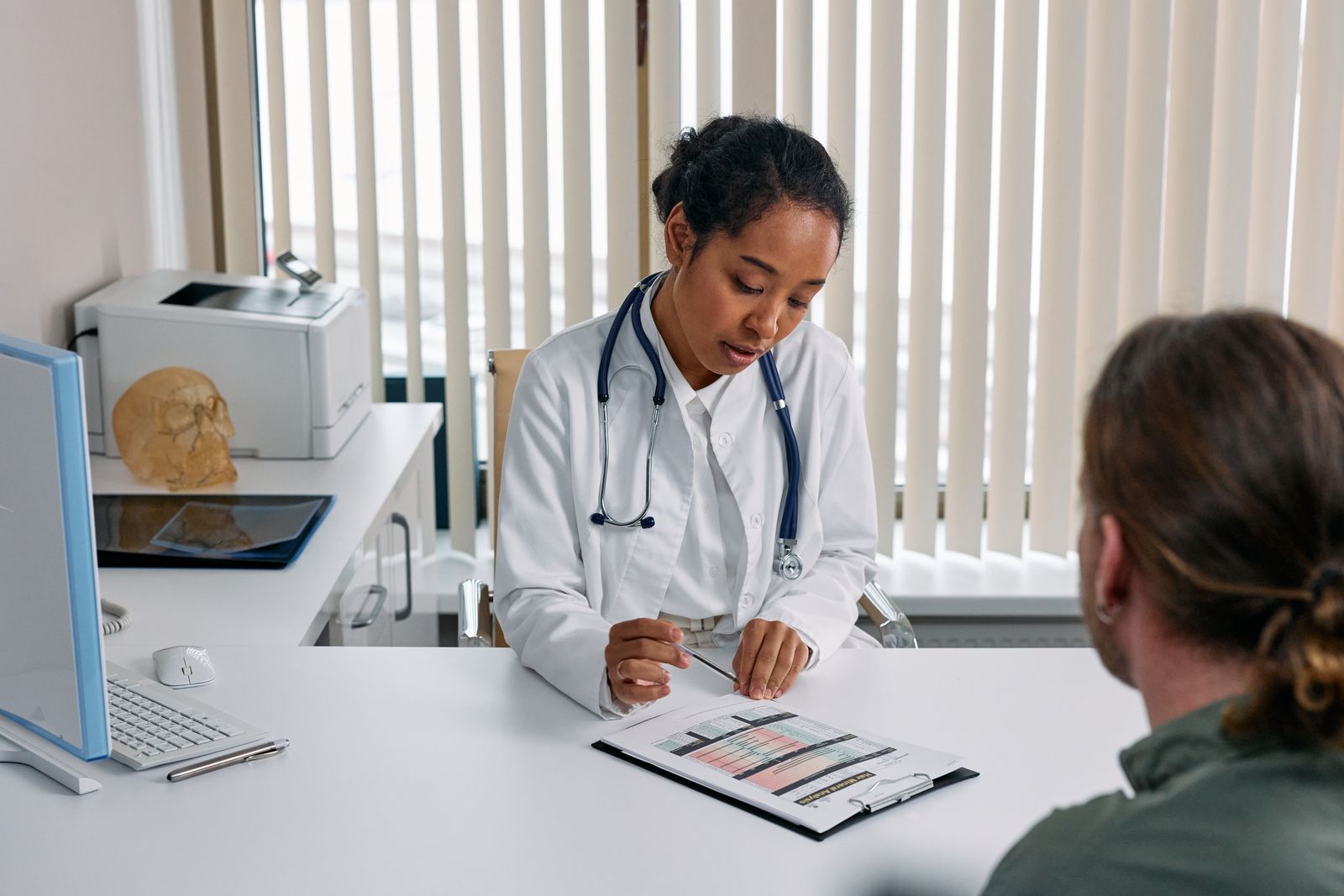 Black woman physician reviewing a care plan with a patient