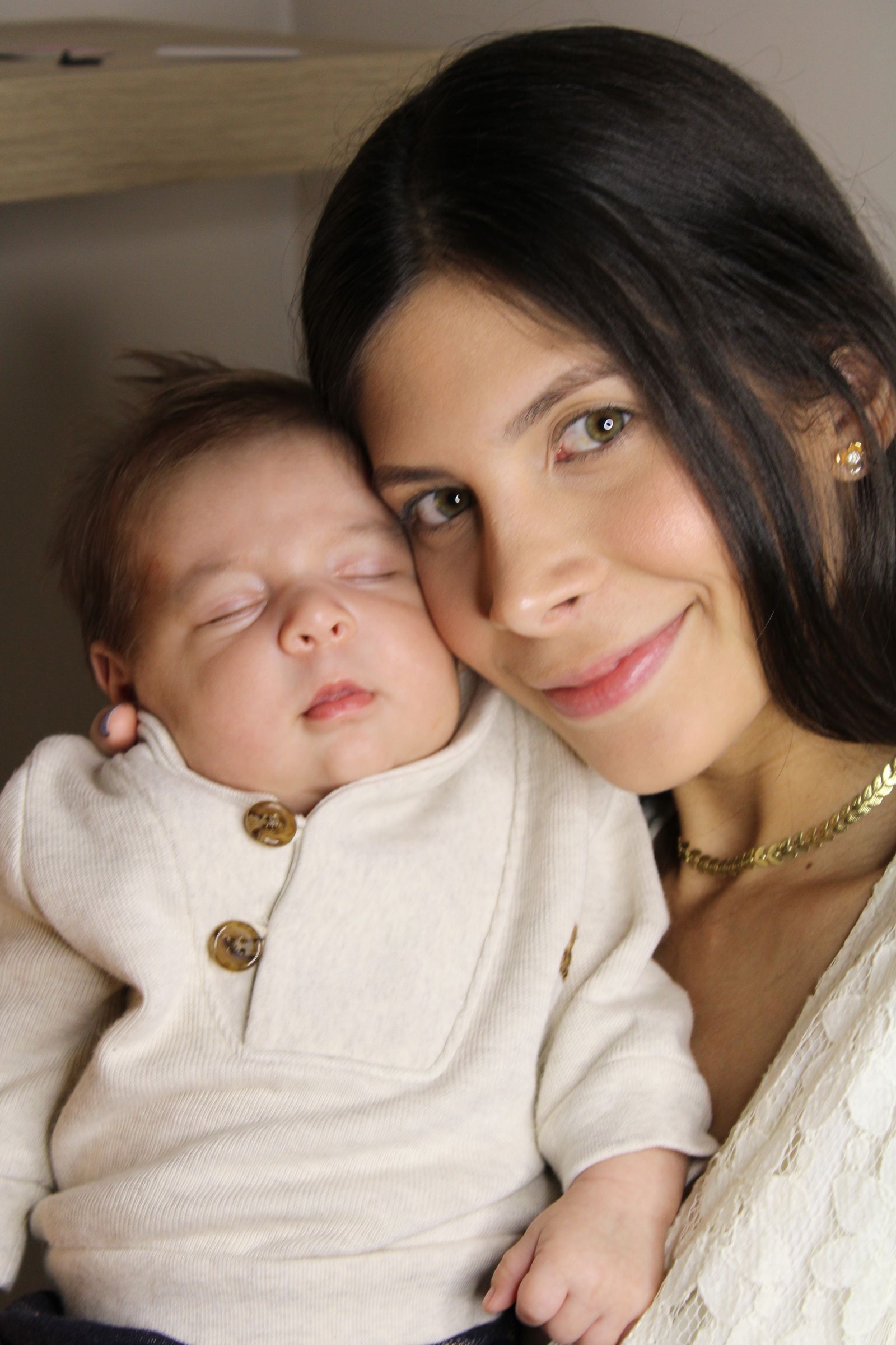 Mother holding her newborn close at home